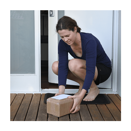 Woman grabbing a package that has been delivered
