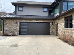 Front view of dark garage door with windows on the side