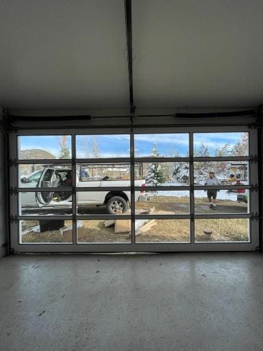 Interior of garage looking out of glass paneled garage door
