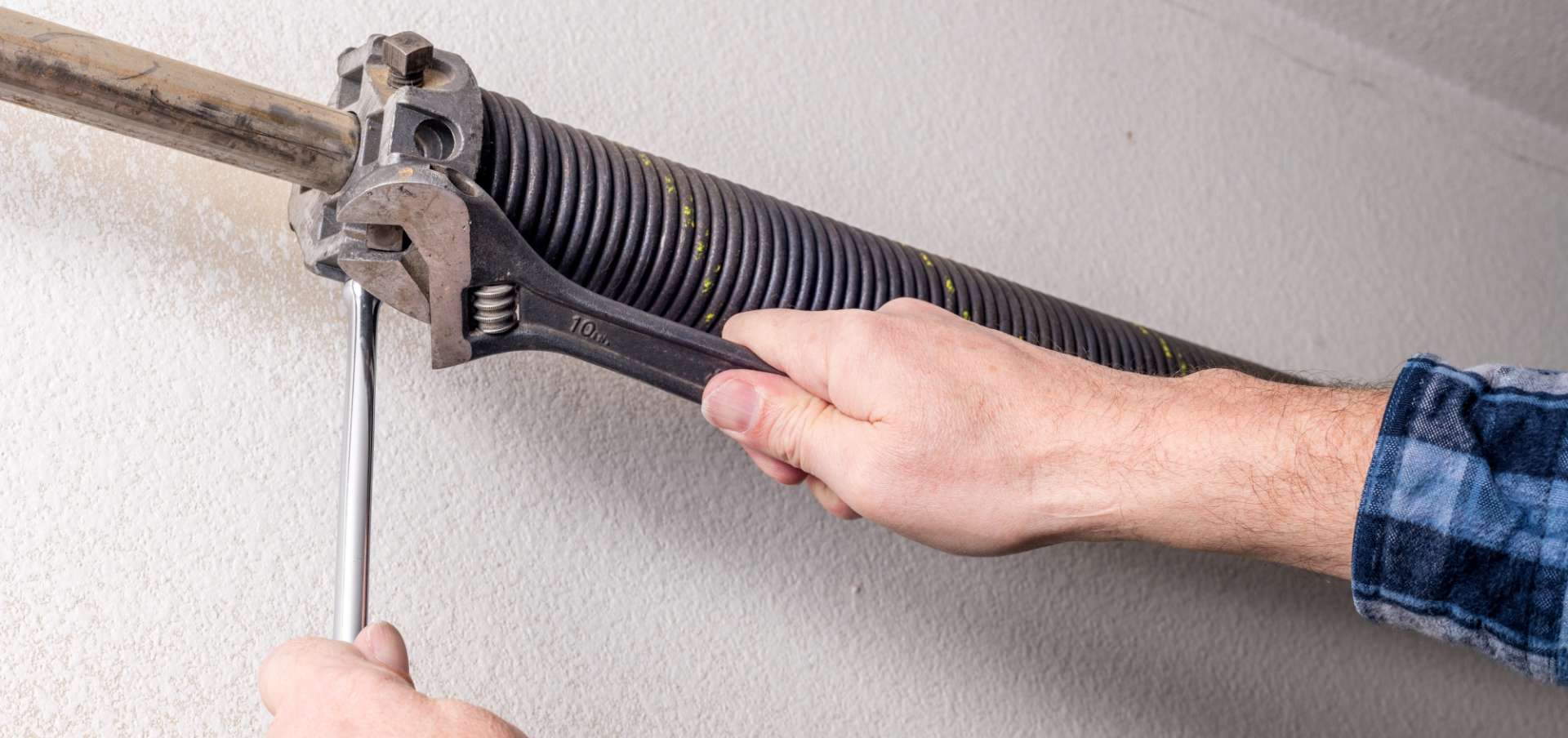 inner-banner4 Man fixing garage spring with wrench