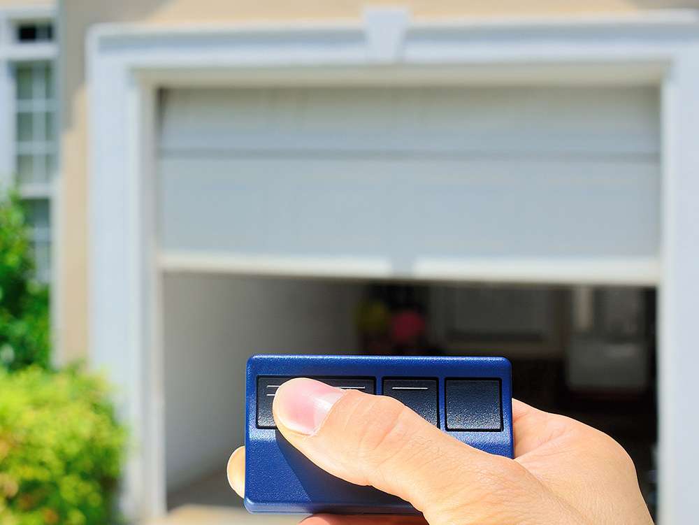 review 04 Man holding a garage door opener, opening his garage