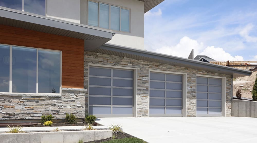 Modern home with glass garage doors